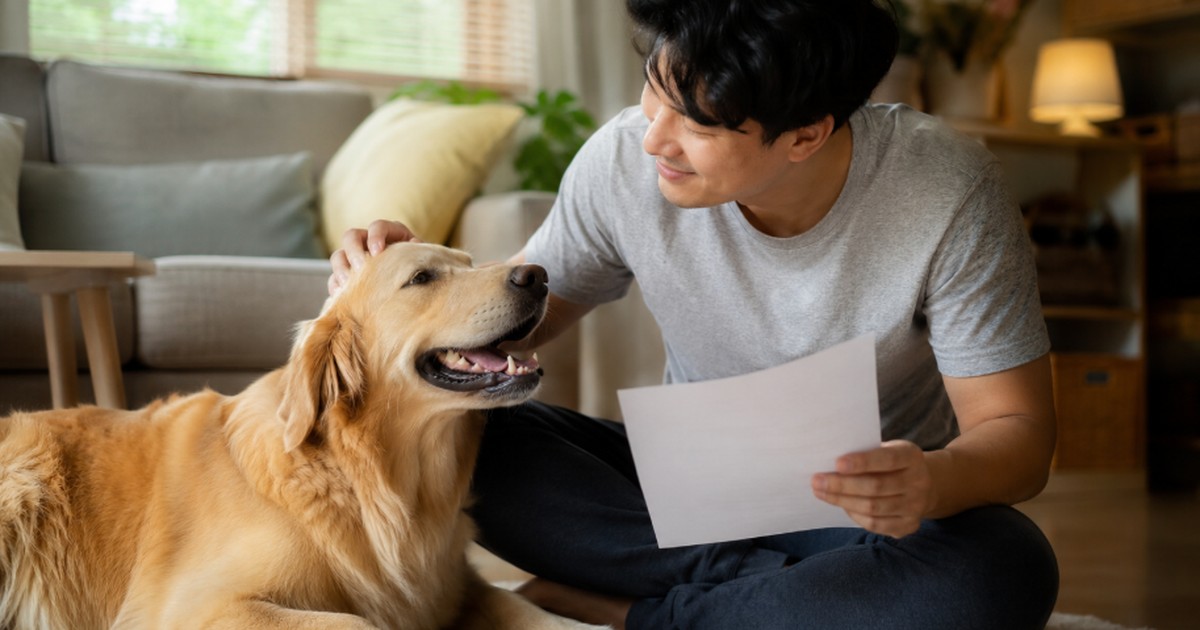 Man petting golden retriever while asking is pet insurance worth it